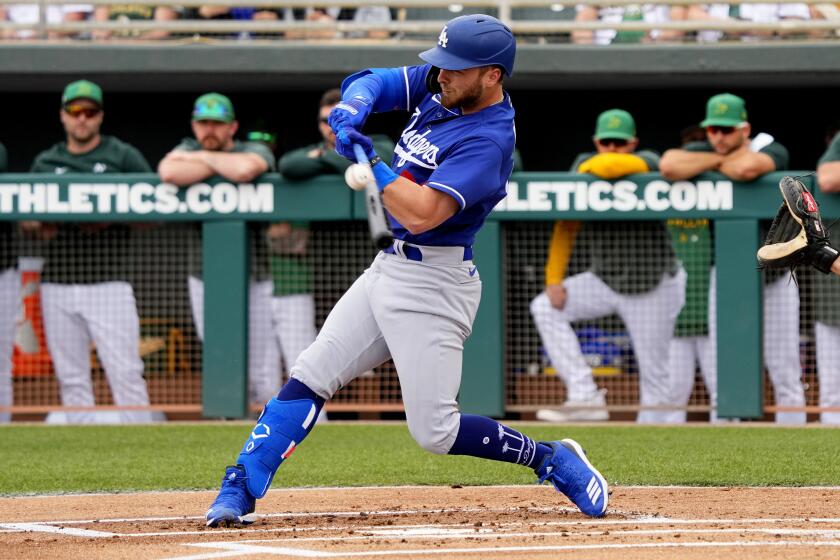 Los Angeles Dodgers' Michael Busch hits during the first inning of a spring training baseball game against the Oakland Athletics, Thursday, March 9, 2023, in Mesa, Ariz. (AP Photo/Matt York)