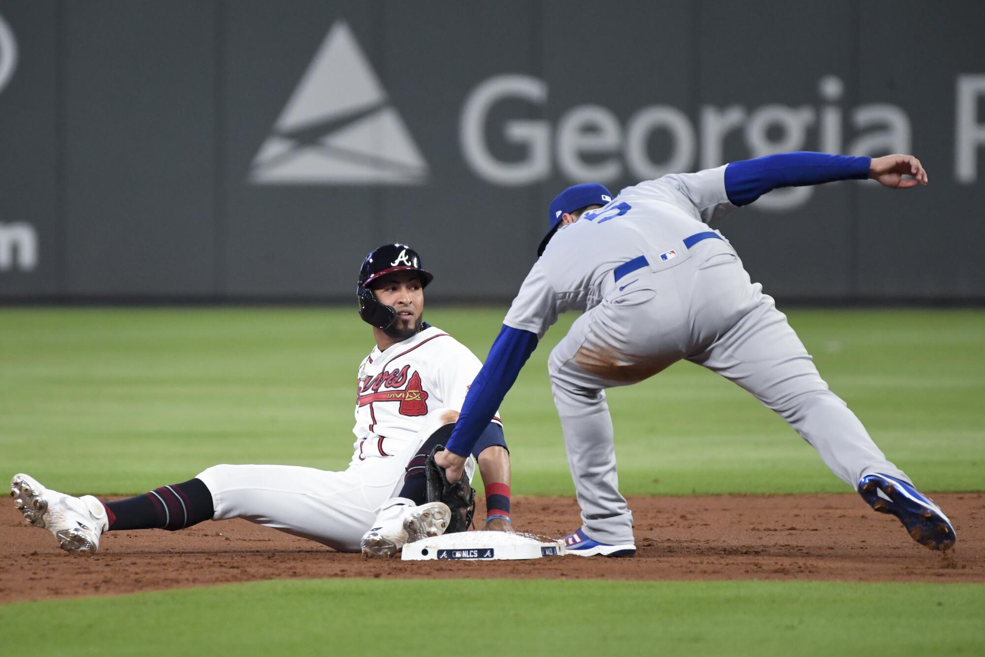 Atlanta Braves' Eddie Rosario, left, steals second base ahead of the tag by Los Angeles Dodgers shortstop Corey Seager