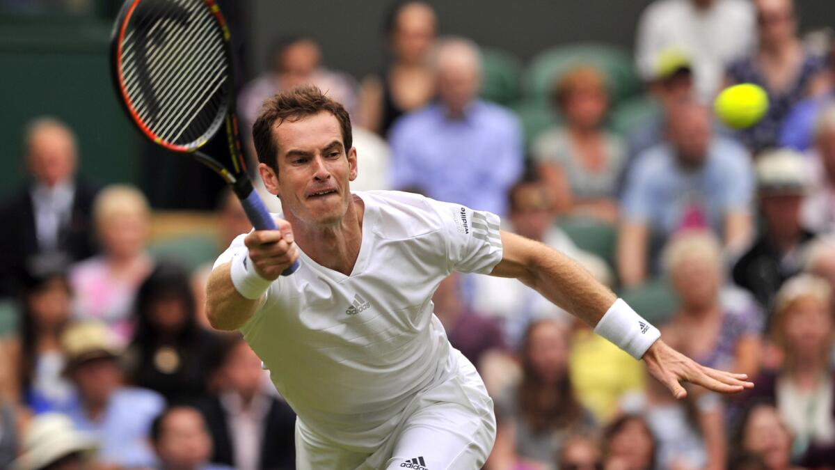 Andy Murray returns a shot during his first-round victory over David Goffin at Wimbledon on Monday.