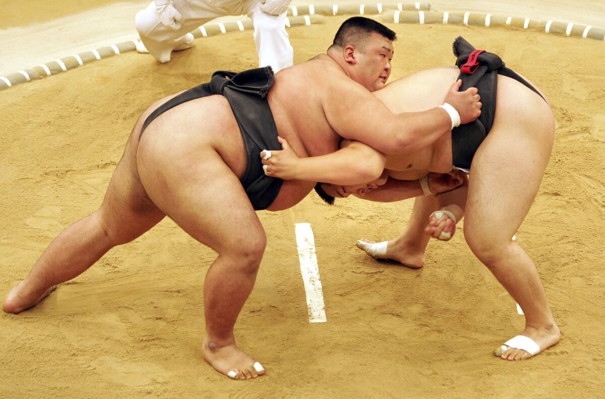 FILE - Sumo wrestler Takayuki Ichihara from Japan, left, fights against Keisho Shimoda from Japan, right, at the heavy weight final of the Sumo tournament within the World Games on July 19, 2005, in Duisburg, Germany. Delayed a year because of the COVID-19 pandemic, the World Games open Thursday, July 7, 2022, in Alabama featuring more than 3,600 athletes participating in non-Olympic events including sumo wrestling, gymnastics, pickleball, martial arts and tug of war. (AP Photo/Martin Meissner, File)