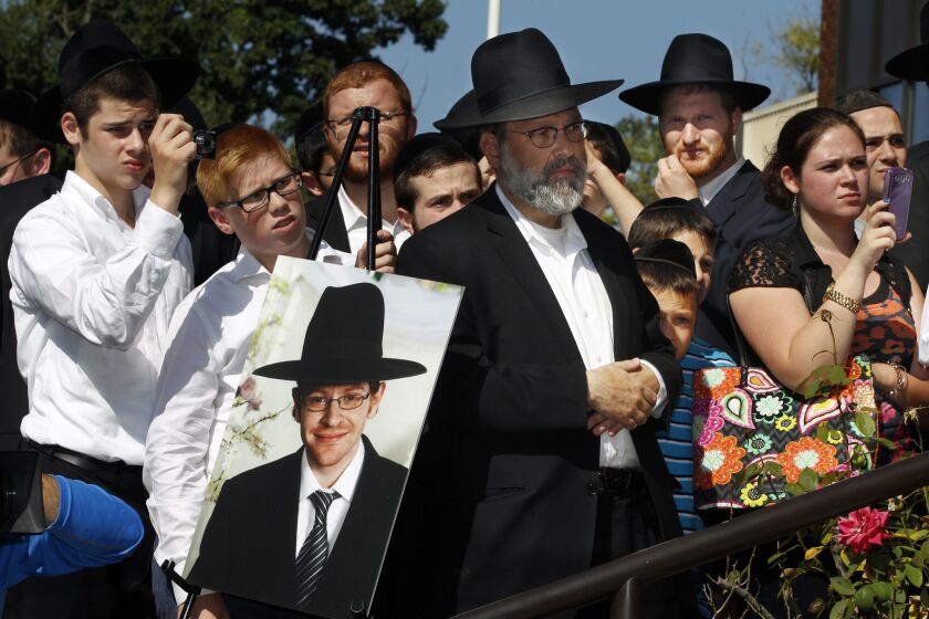 A photograph of Aharon Sofer, 23, is displayed at a news conference in Lakewood, N.J. Israeli police said Thursday they had found a man's body in the area near where he disappeared outside Jerusalem.