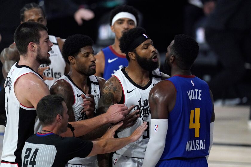 Los Angeles Clippers' Marcus Morris Sr., second from right, and Denver Nuggets' Paul Millsap scuffle during the first half of an NBA conference semifinal playoff basketball game, Friday, Sept. 11, 2020, in Lake Buena Vista, Fla. (AP Photo/Mark J. Terrill)