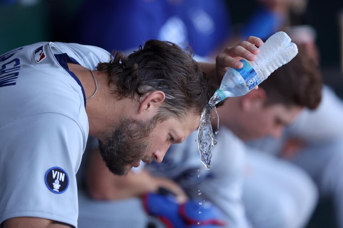Clayton Kershaw pours water on his head during Thursday's game.