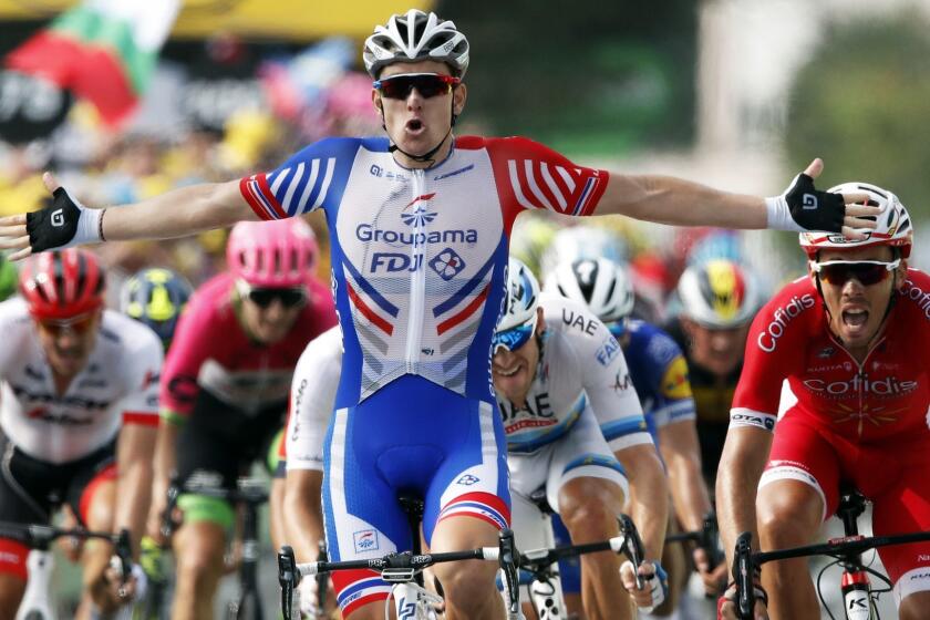 France's Arnaud Demare, left, celebrates as he crosses the finish line to win the eighteenth stage of the Tour de France cycling race over 171 kilometers (106.3 miles) with start in Trie-sur-Baise and finish in Pau, France, Thursday, July 26, 2018. France's Christophe Laporte finished second. (AP Photo/Christophe Ena)