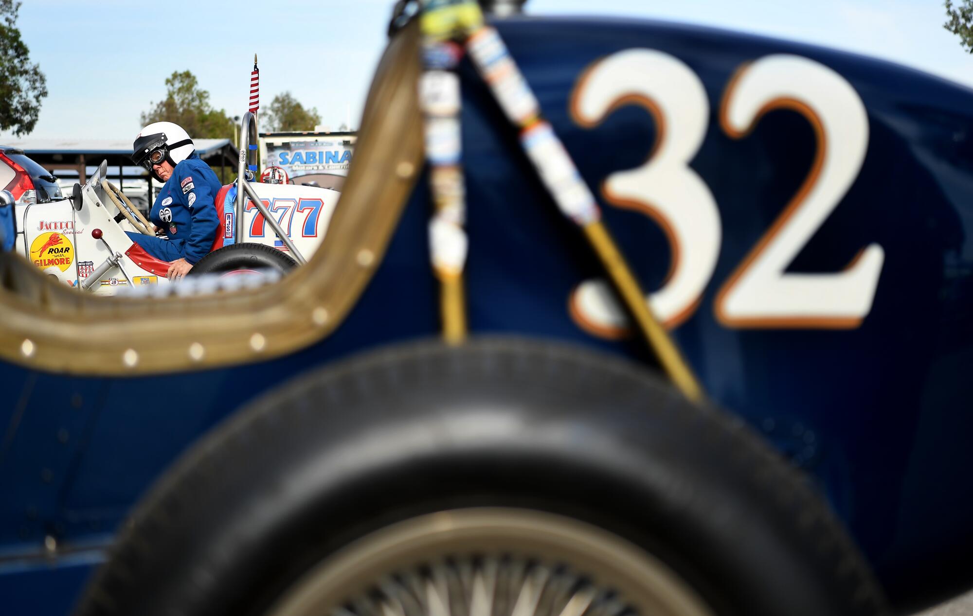 Dennis Howland climbs into his race car before a practice run at Buttonwillow Raceway in Buttonwillow, Calif., on Saturday.