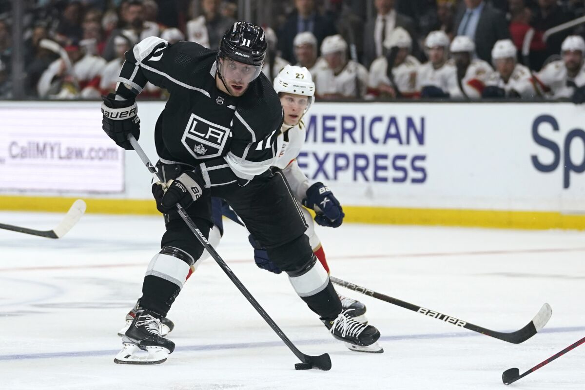 FILE - Los Angeles Kings center Anze Kopitar (11) controls the puck against Florida Panthers center Eetu Luostarinen (27) during the second period of an NHL hockey game March 13, 2022, in Los Angeles. Kopitar led the Kings with 67 points last season. (AP Photo/Ashley Landis, File)