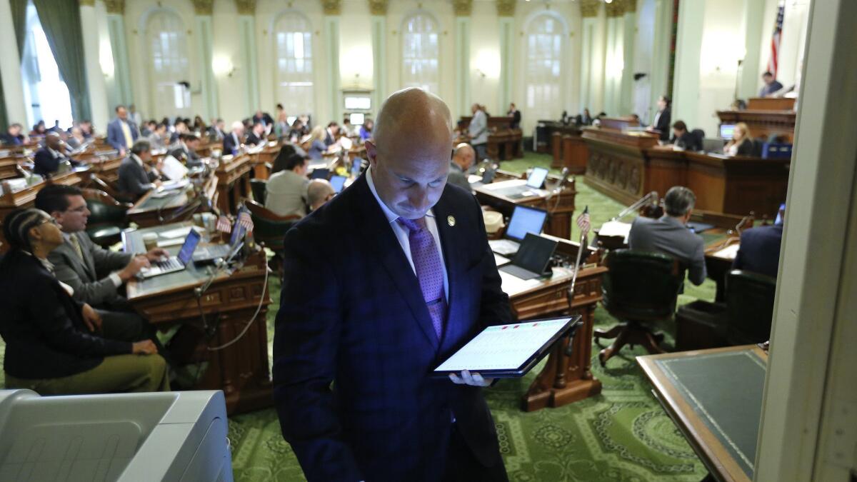 Assemblyman Heath Flora (R-Ripon) looks up a bill on an Assembly computer at the Capitol on Thursday. Lawmakers wrapped up their work for the year on Friday.