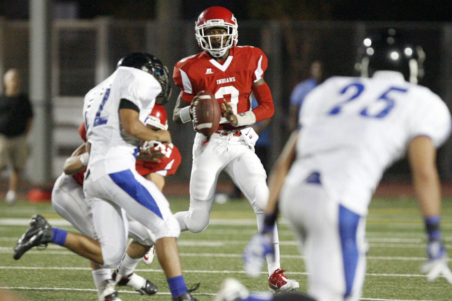 Burroughs' Oharjee Brown, center, looks for an open pass during a game against North Hollywood at John Burroughs High School in Burbank on Friday, September 7, 2012.