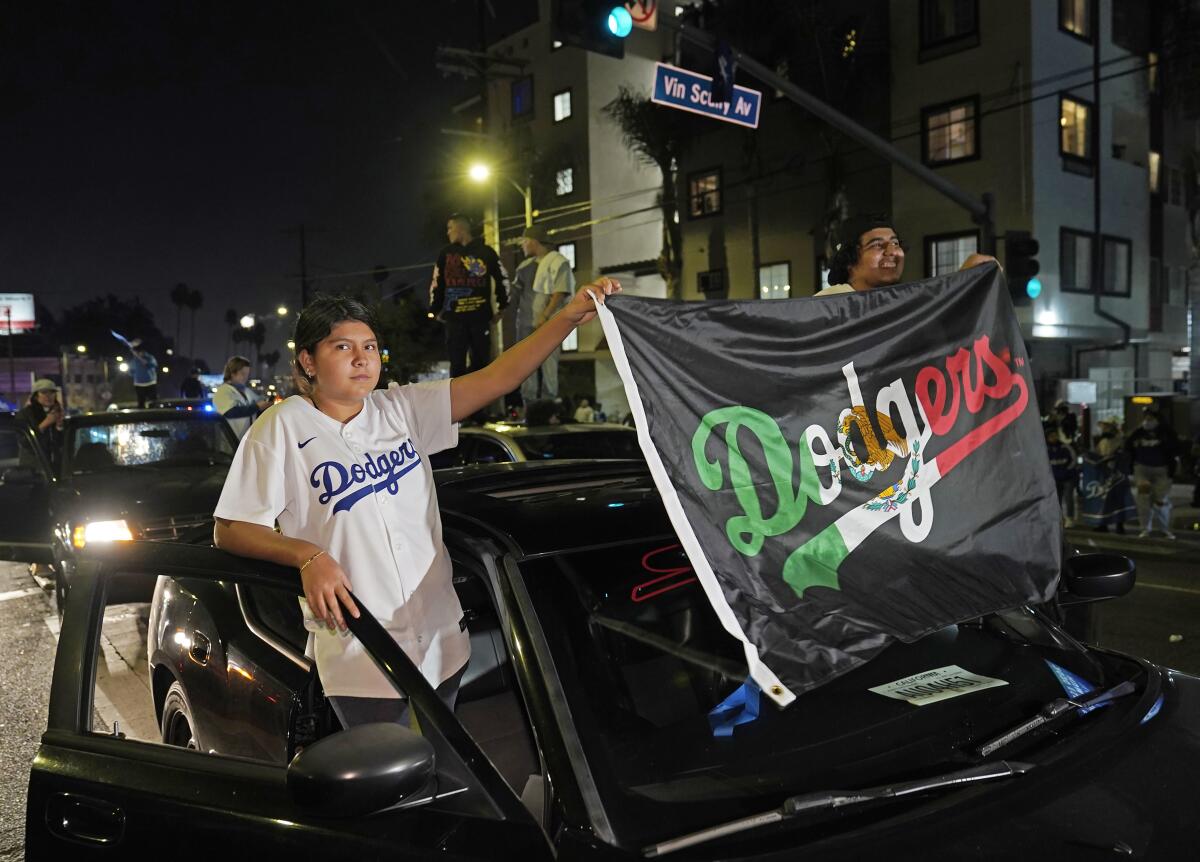 Los Angeles Dodgers fans celebrate on Sunset Blvd.  