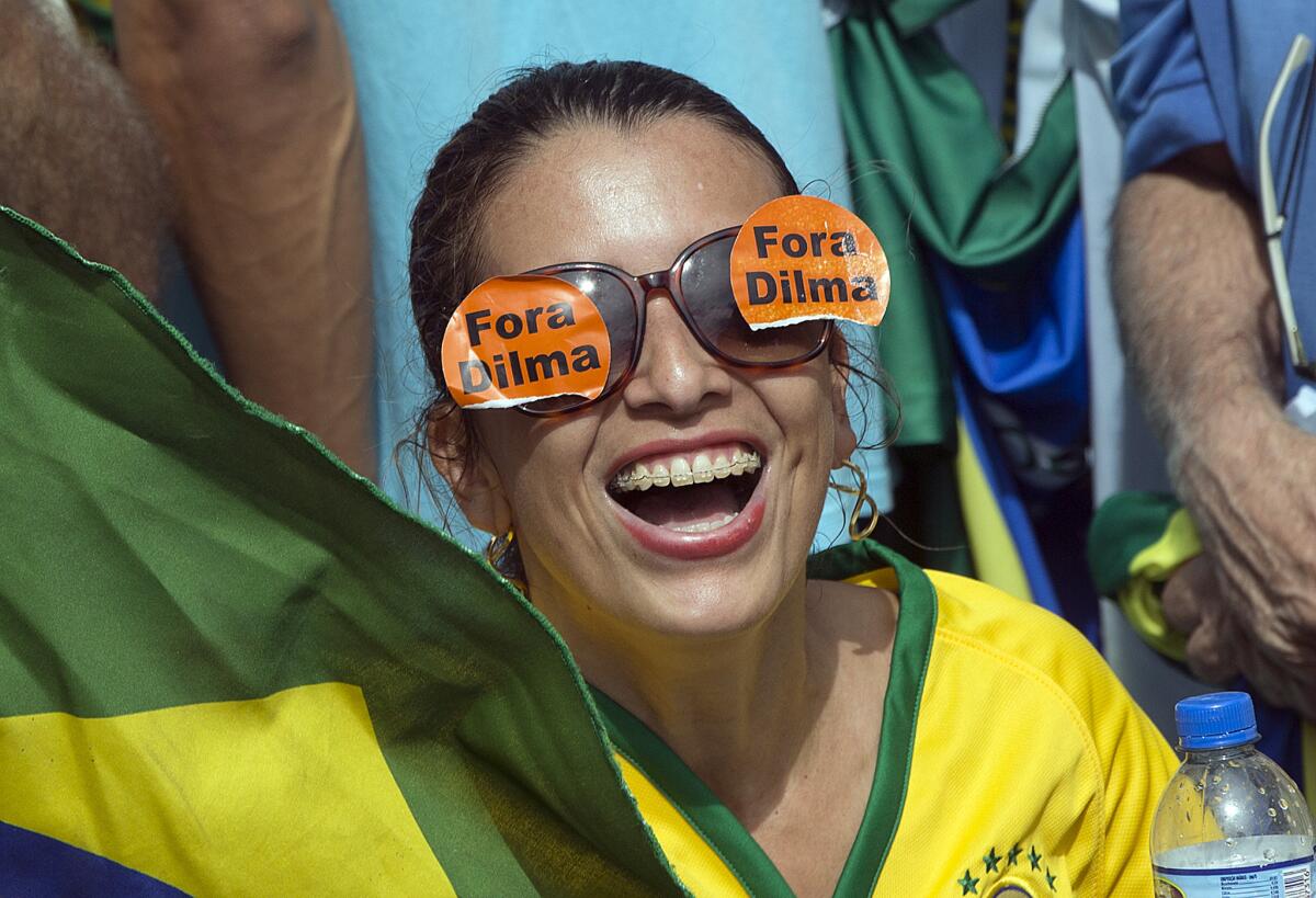 A demonstrator wears glasses that read in Portuguese "Dilma Out" during a march in Sao Paulo, Brazil, on Sunday demanding the impeachment of President Dilma Rousseff and to criticize government corruption.