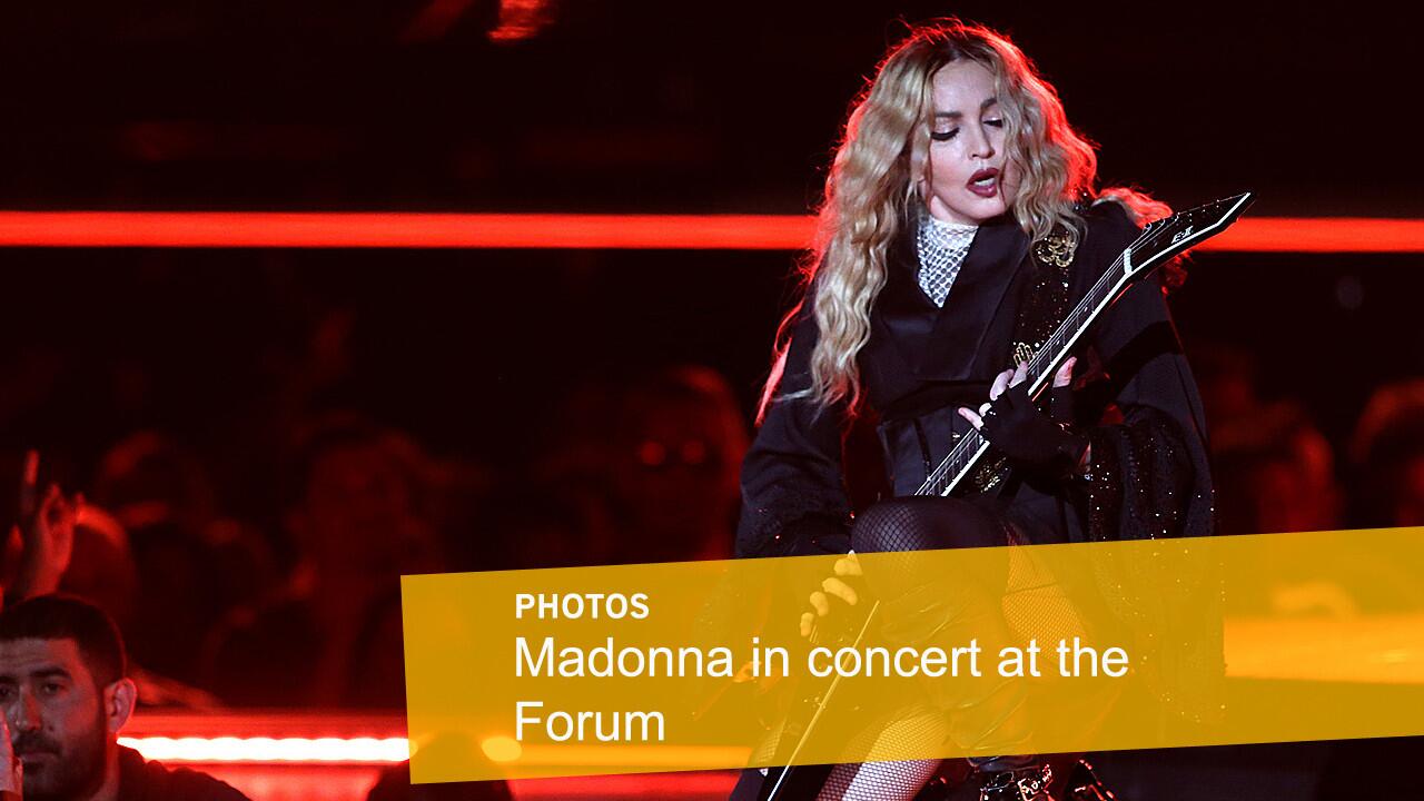 Madonna flexes her guitar skills at the Forum.