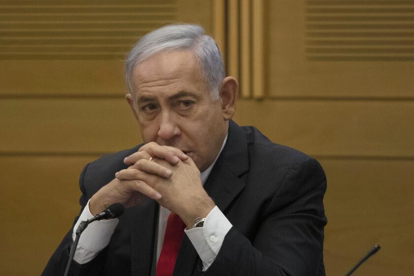 FILE - In this June 14, 2021 file photo, former Israeli Prime Minister Benjamin Netanyahu speaks to right-wing opposition party members, at the Knesset, Israel's parliament, in Jerusalem. Israel's prime minister's office has urged Netanyahu to return dozens of expensive gifts he received while serving in the nation's top job. Netanyahu, Israel's longest-serving prime minister, now opposition leader, has developed a reputation for enjoying a lavish lifestyle, often at taxpayer expense, and is on trial for allegedly accepting expensive gifts from wealthy associates. (AP Photo/Maya Alleruzzo, File)