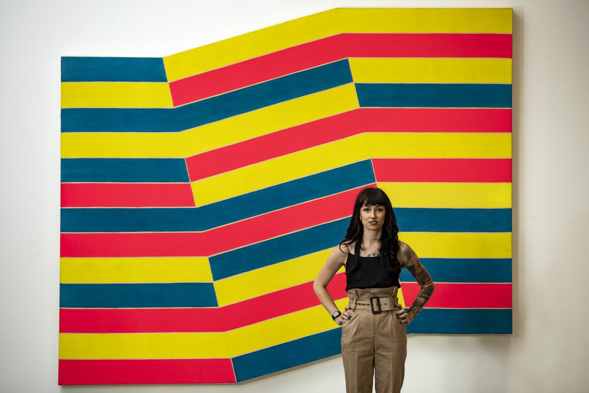 Kamila Korbela stands in front of "Bampur" by Frank Stella.