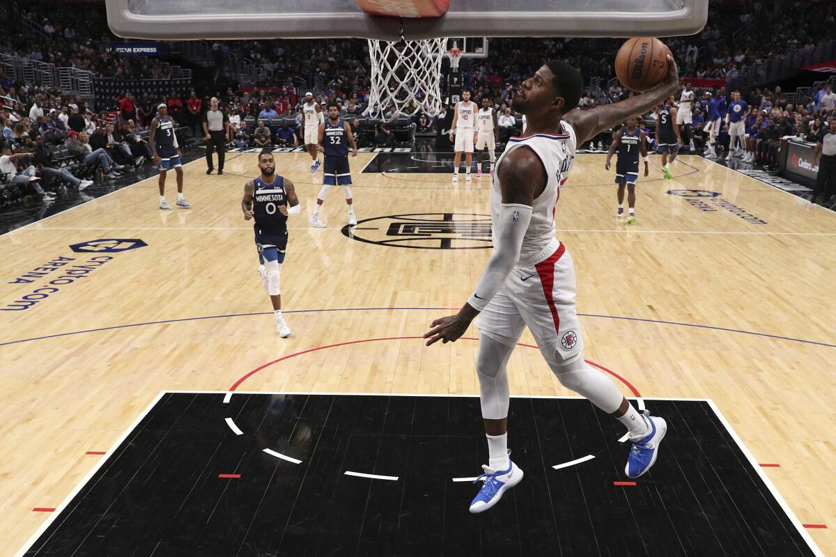 LA Clippers forward Paul George dunks the ball 