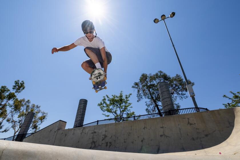 Lake Forest, CA - July 31: Skateboarder Greyson Godfrey, 20, of Rancho Santa Margarita, soars high over the coping at Etnies Skate Park Lake Forest in Lake Forest Wednesday, July 31, 2024. A recent study explored the best way to get as high out of the bowl as possible to do tricks. Skaters accomplish this by using a motion called pumping (crouching and standing up on the board to build speed). The optimal motion to capture is this: The skater enters the bowl crouching. They move to a standing position as they skate down the curved part. Over the flat part down in the bowl, they move into a crouching position again. Then finally, as they travel up the curved part on the other side, the push up into a standing position again(Allen J. Schaben / Los Angeles Times)