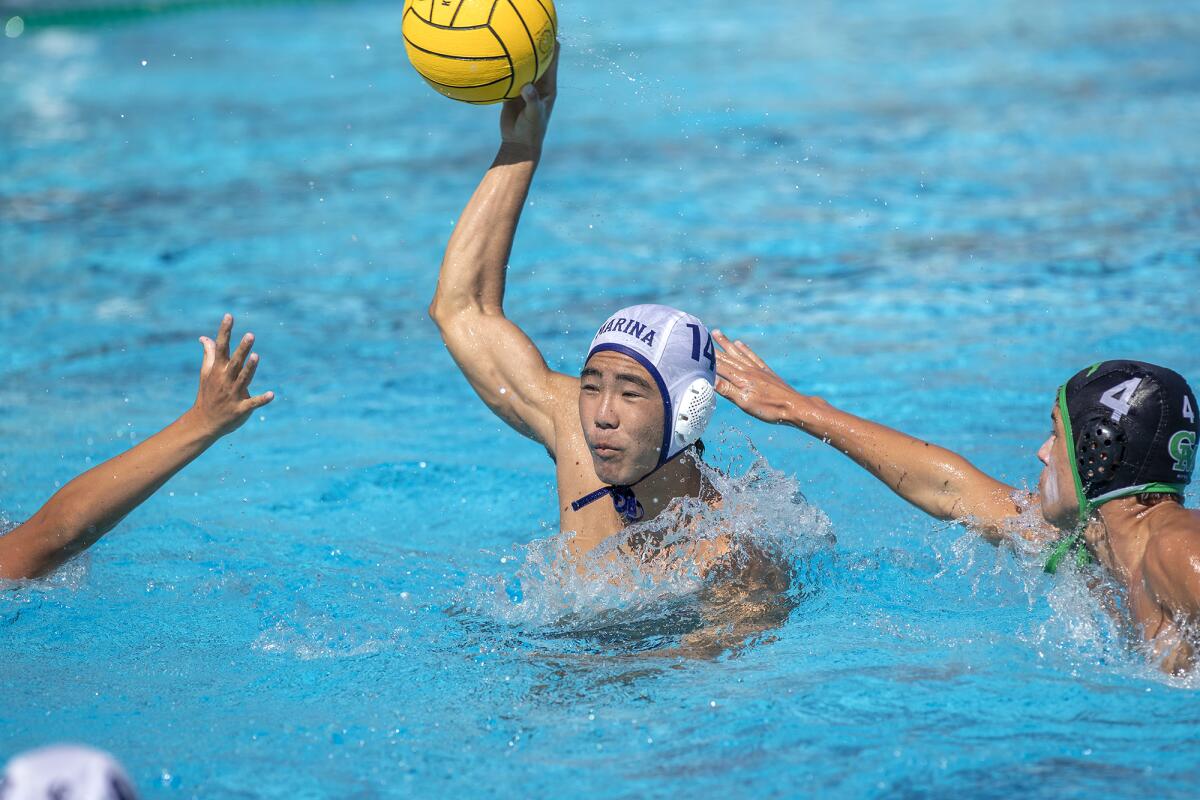 Marina's Lico Yuno takes a shot under pressure from Costa Mesa's Wes Brazda, right, during a nonleague game on Aug. 31.