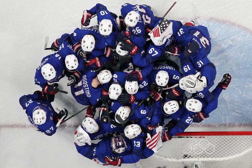 United States players celebrate after winning a preliminary round men's hockey game between United States and Germany at the 2022 Winter Olympics, Sunday, Feb. 13, 2022, in Beijing. (AP Photo/Petr David Josek)