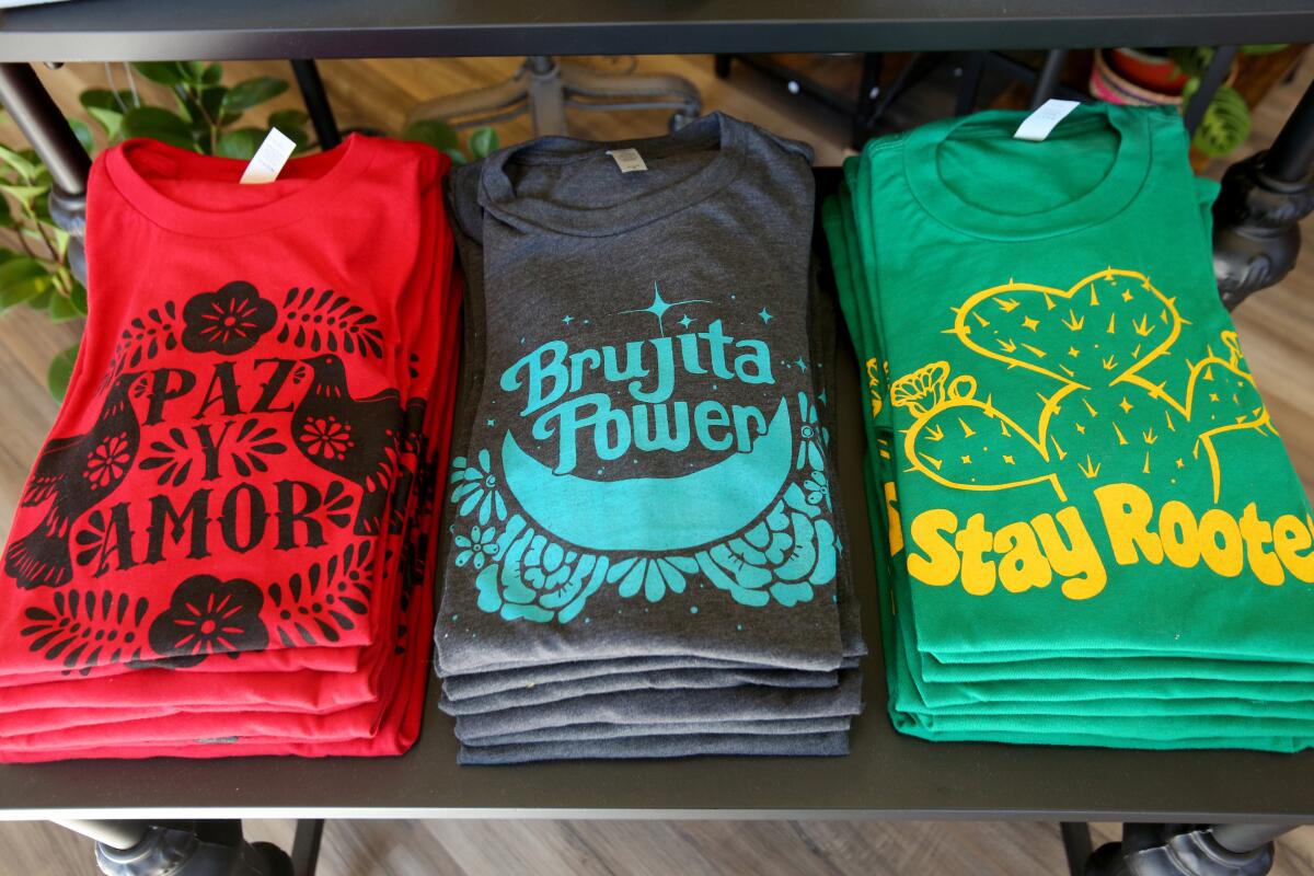 Stacks of colorfully designed T-shirts.