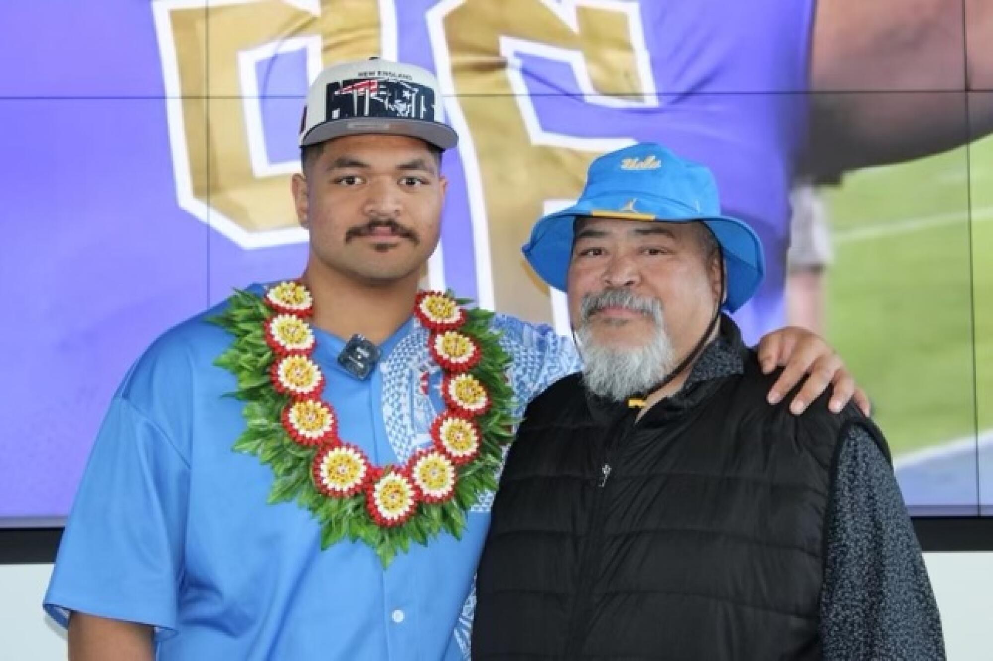 Atonio Mafi poses for a photo with his father, Peter, after being drafted by the New England Patriots.