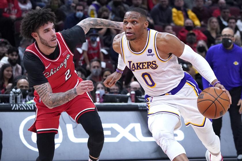 Los Angeles Lakers guard Russell Westbrook, right, drive to the basket against Chicago Bulls.