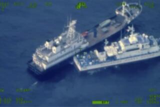 This image released by the Armed Forces of the Philippines, shows a Chinese militia vessel, top, and Philippine coast guard vessel BRP Cabra as they approach Second Thomas Shoal, locally called Ayungin Shoal, at the disputed South China Sea on Sunday Oct. 22, 2023. (Armed Forces of the Philippines via AP)