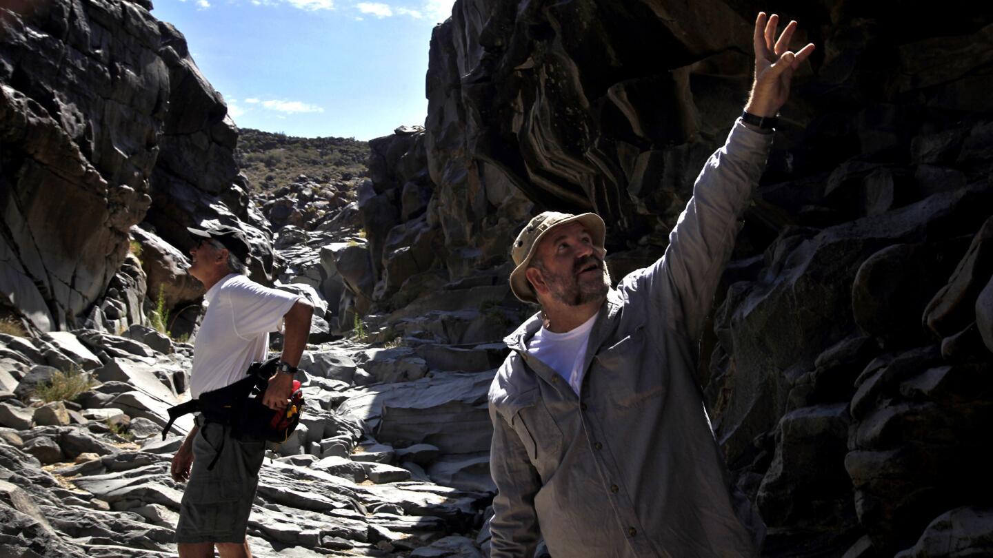 Michael Baskerville, 51, right, explores Little Petroglyph Canyon Paul Goldsmith, who did a documentary on the petroglyphs.