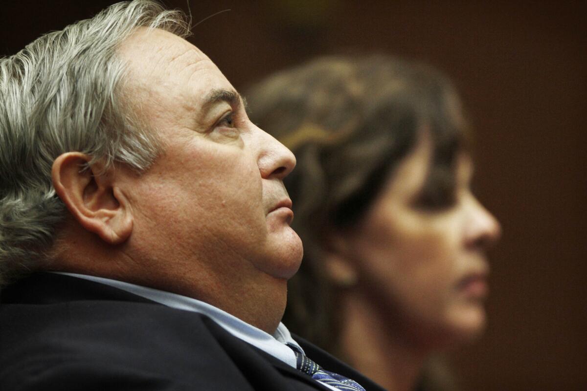 Former Bell City Administrator Robert Rizzo sits in court alongside former second-in-command Angela Spaccia in 2011.