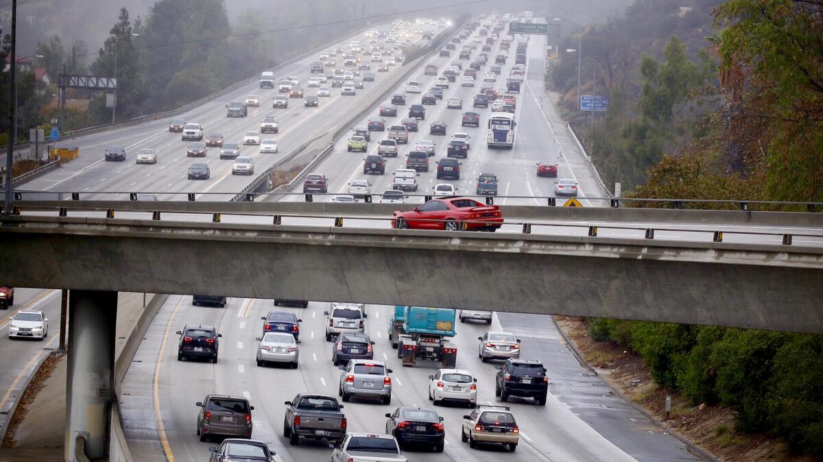 Drivers navigate slick roads on the rain-soaked 134 Freeway in the Eagle Rock Monday morning.