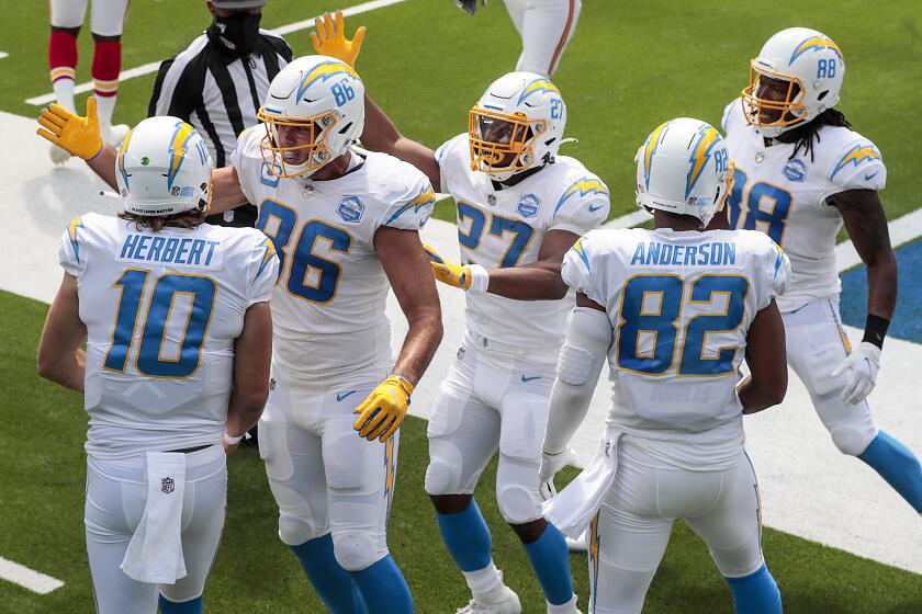 Inglewood, CA, Sunday, September 20, 2020 - Quarterback Justin Herbert #10 of the Los Angeles Chargers celebrates with teammates after scoring his first career touchdown on a first quarter scramble against the Kansas City Chiefs at SoFi Stadium. (Robert Gauthier/ Los Angeles Times)