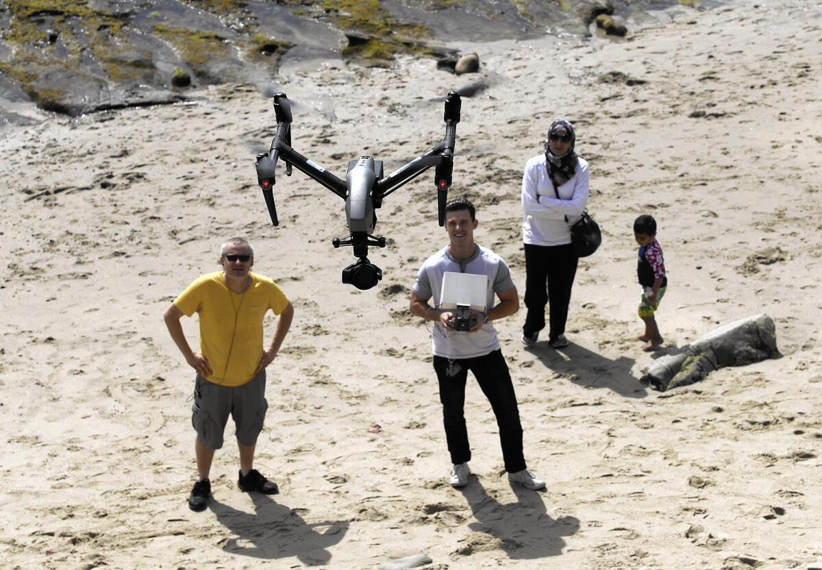 Licensed drone pilot John Barrett flies his professional model camera drone above Rockpile Beach in Laguna Beach on Friday.