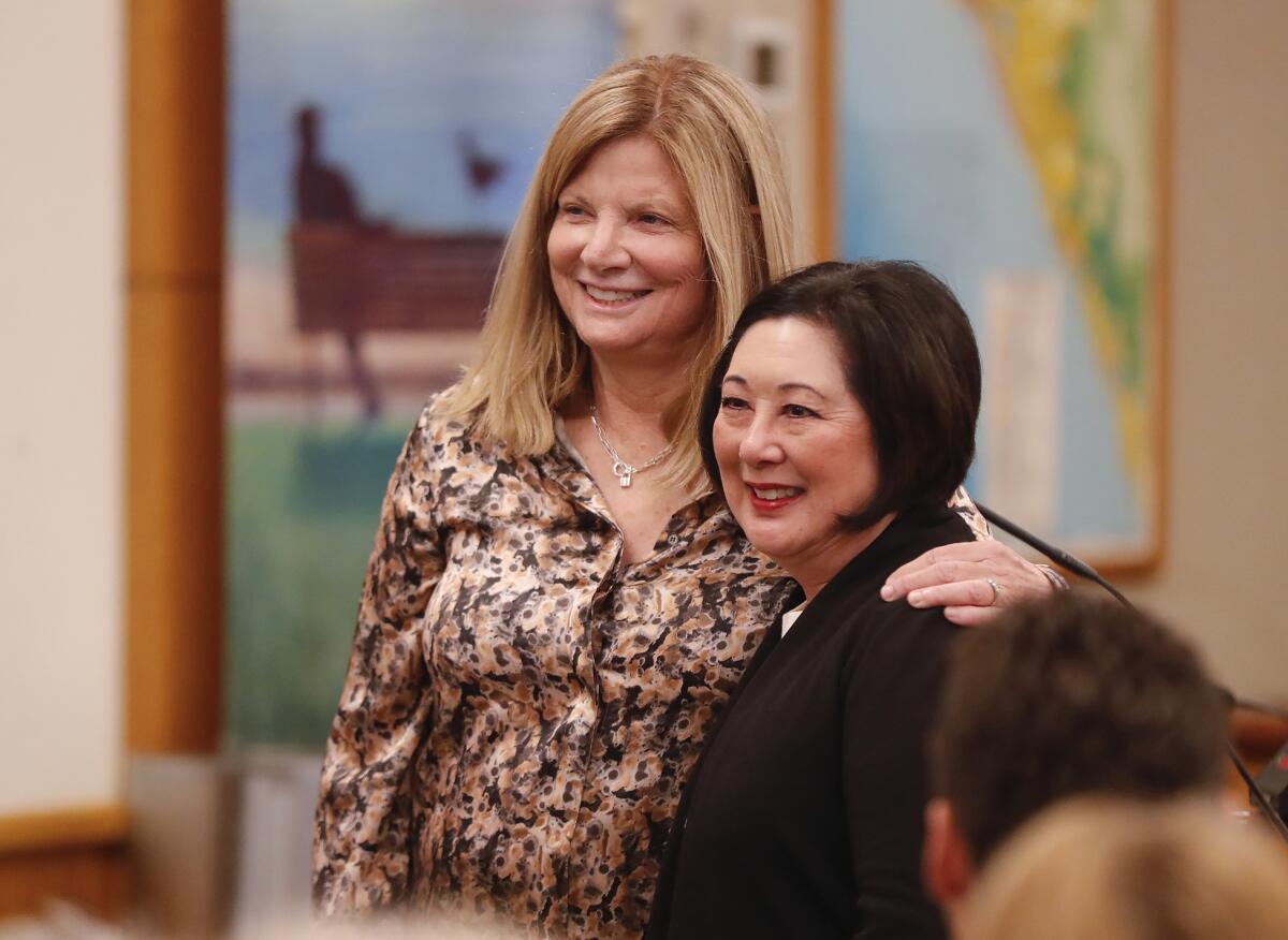 Outgoing Laguna Beach Mayor Sue Kempf, left, acknowledges outgoing Orange County Supervisor Lisa Bartlett for her work.