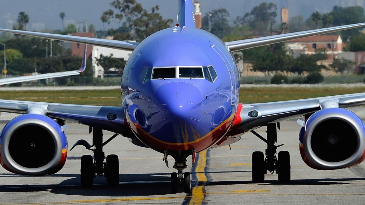A Southwest Airlines Boeing 737-700 passenger jet taxis after arriving at Los Angeles International Airport on April 5, 2011. The airline has agreed to pay $15 million to settle a lawsuit that alleges collusion among the country's four biggest carriers.