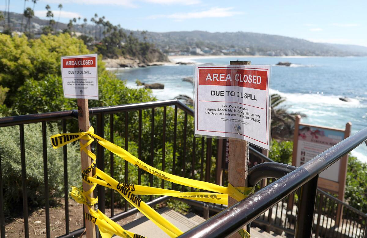 A beach closure sign at Rockpile Beach was in place Tuesday due to the recent oil spill off Huntington Beach.