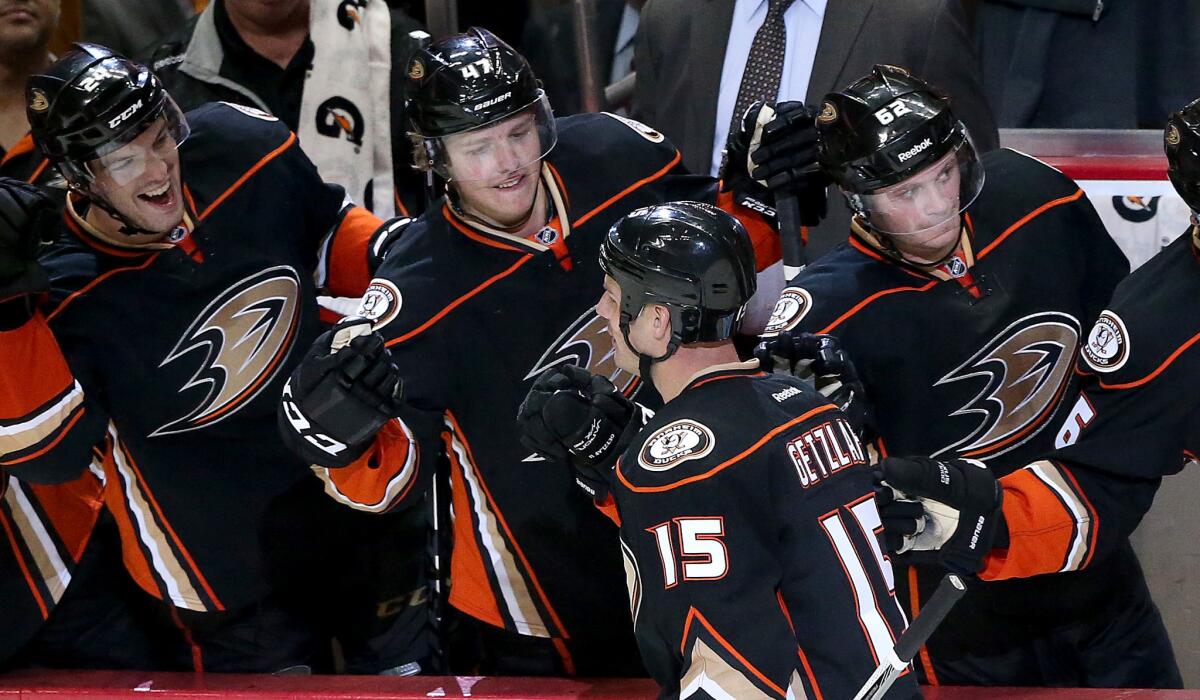 Ducks teammates congratulate center Ryan Getzlaf after he scored a goal late in the game to seal a 4-2 win over the Jets in Game 1 of the first-round playoff series on Thursday night.