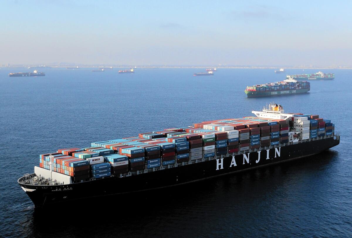 Huge cargo ships anchor offshore at the ports of Los Angeles and Long Beach.