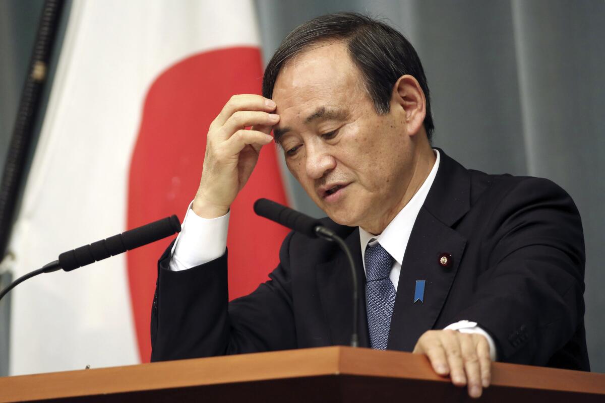 FILE - In this Feb. 1, 2015, file photo, Japan's Chief Cabinet Secretary Yoshihide Suga speaks during a press conference at the prime minister's official residence in Tokyo after the release of an online video that purported to show an Islamic State group militant beheading Japanese journalist Kenji Goto. Suga, a longtime loyal assistant and the public face of outgoing Prime Minister Shinzo Abe in daily media briefings, has emerged as a favorite to succeed him in an upcoming internal party vote. Suga is set to announce his candidacy and key policies later Wednesday, Sept. 2, 2020. (AP Photo/Eugene Hoshiko, File)