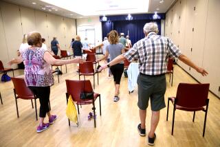 CULVER CITY, CA - JULY 9, 2024 - Carolynn Middleton, 75, left, and Larry Nathan, 87, right, join other seniors who participate in the Balance Challenge Class at the Culver City Senior Center in Culver City on July 9, 2024. (Genaro Molina/Los Angeles Times)