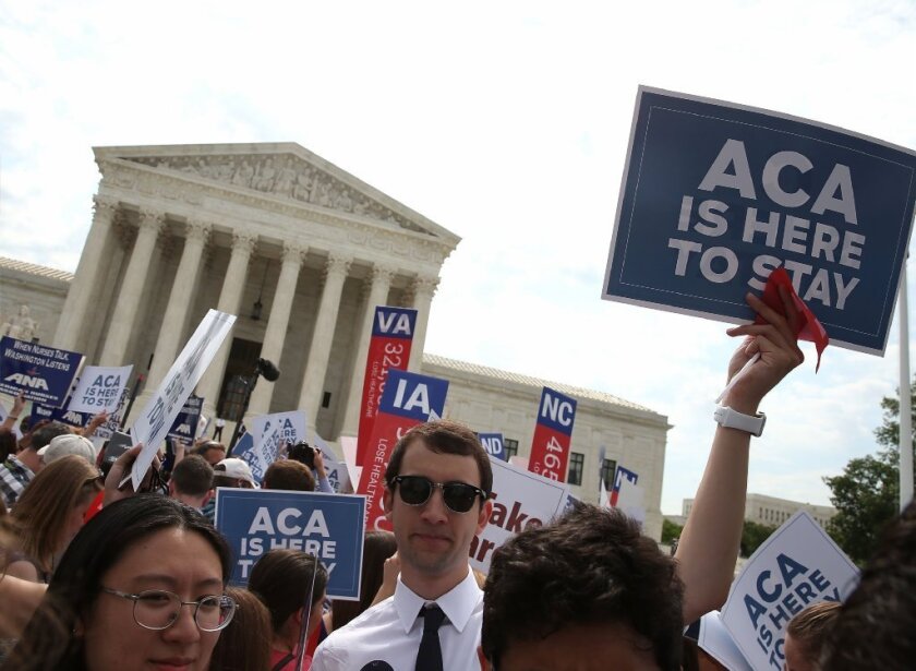 Supporters of the Affordable Care Act cheer outside the Supreme Court building after the June 25 announcement of the court's decision upholding the healthcare law's subsidies nationwide.