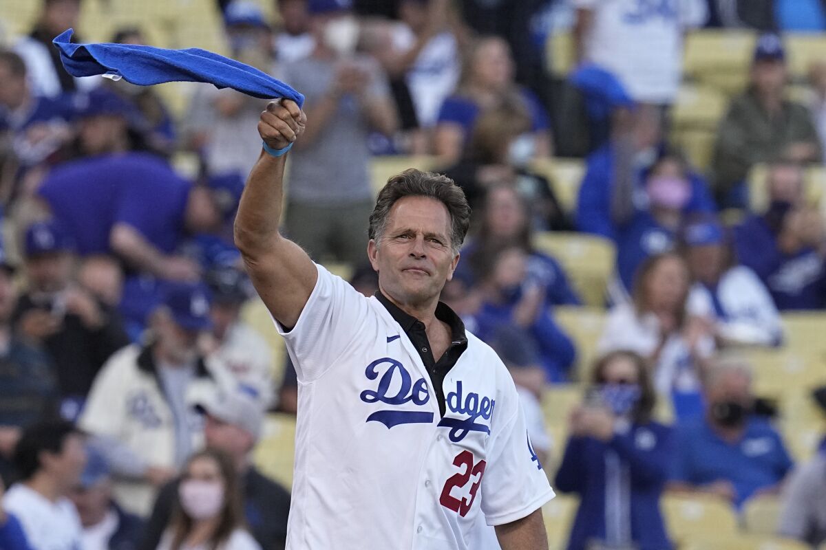 Eric Karros waves a towel before before Game 4 of the 2021 NLCS.