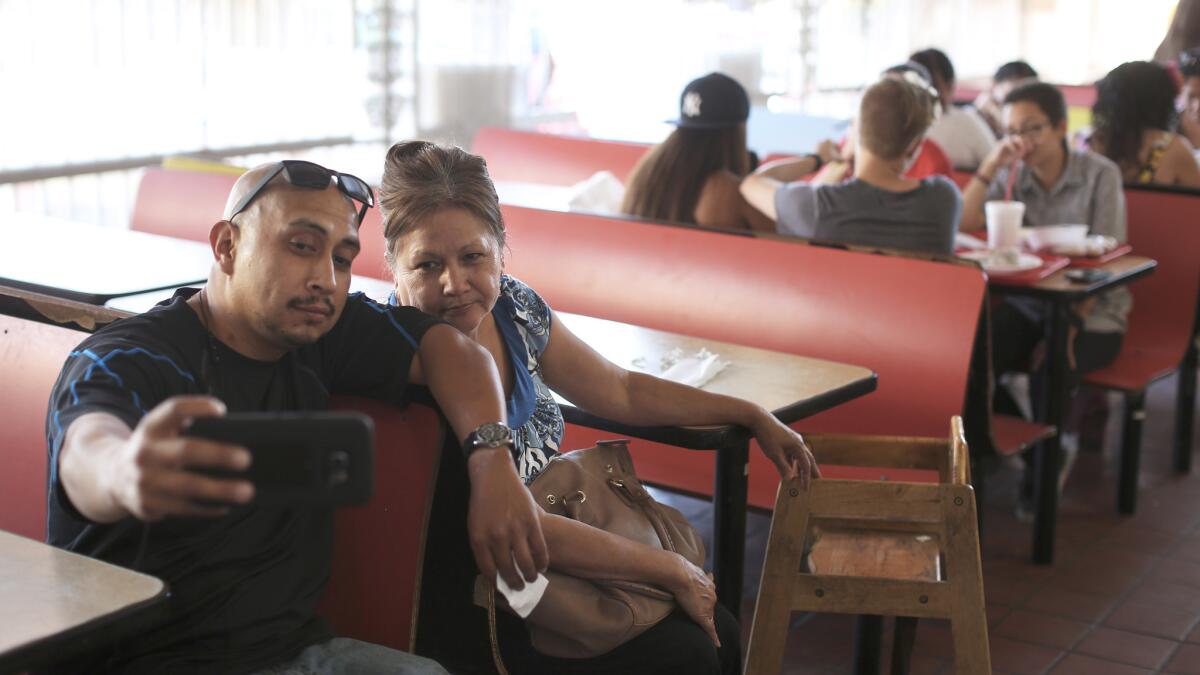 "I've been coming here since I was in her stomach," said Rudy Ortiz, 34, says of his mother, Enedina Ortiz, 62 at Carnitas Michoacan.