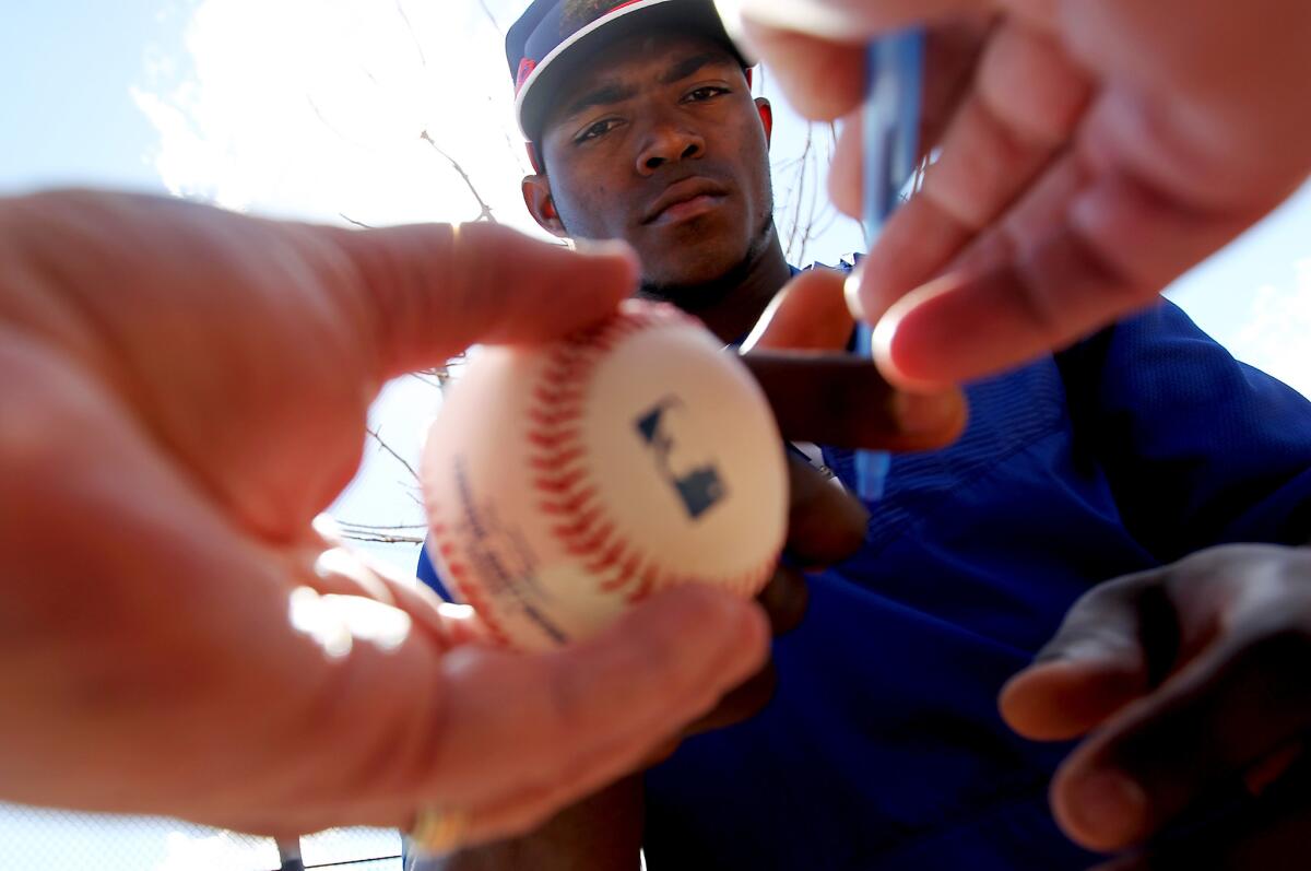 Dodgers outfielder Yasiel Puig signs autographs at Camelback Ranch on March 3.