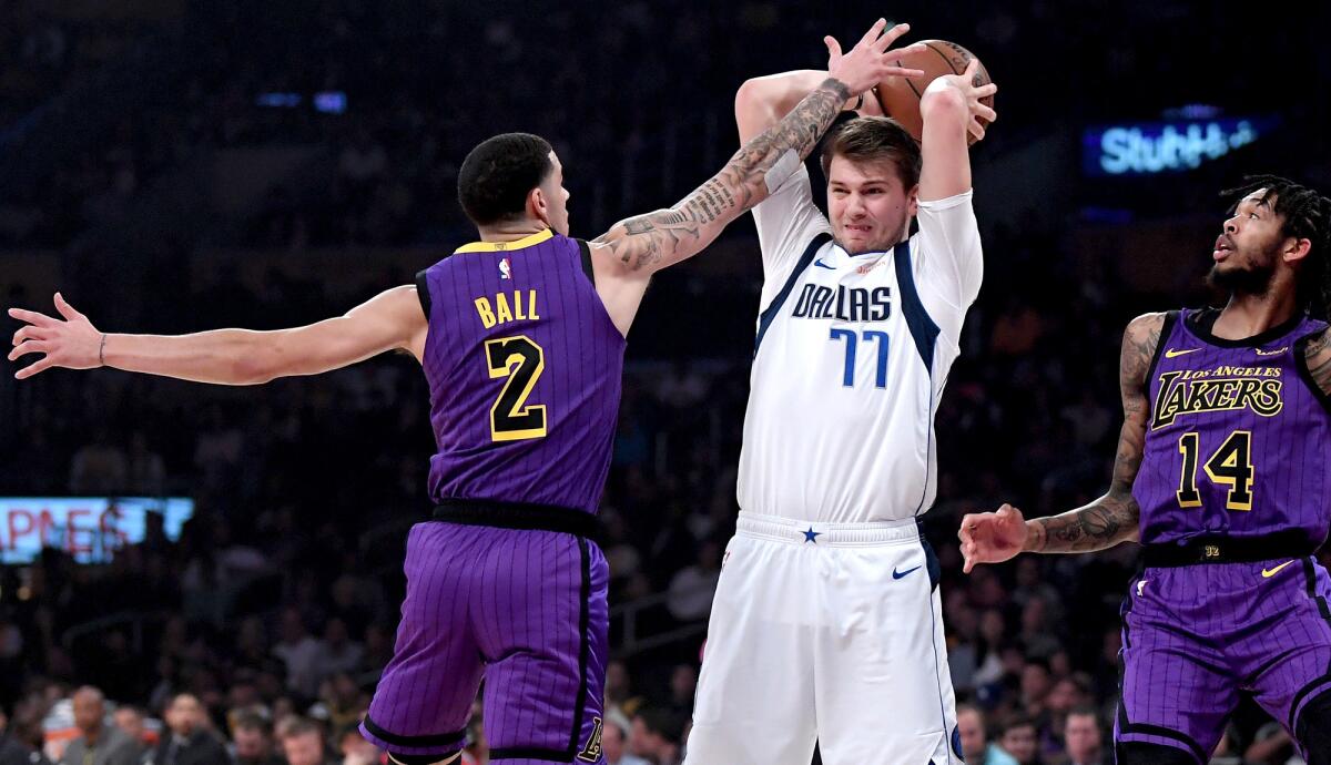 Lakers guard Lonzo Ball pressures Mavericks guard Luka Doncic during the game Friday night at Staples Center.