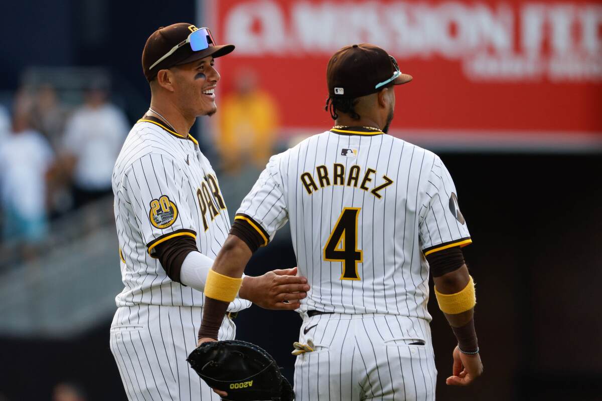 Padres third baseman Manny Machado and first baseman Luis Arraez celebrate after beating the Marlins