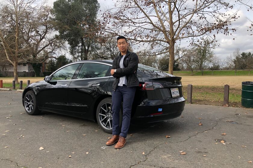 SACRAMENTO, CALIF. - DEC. 24, 2019 - Ethan Dang is photographed with his 2019 Tesla Model 3. He does peer-to-peer sharing of the car with Turo. (Photo: Megan Dang)