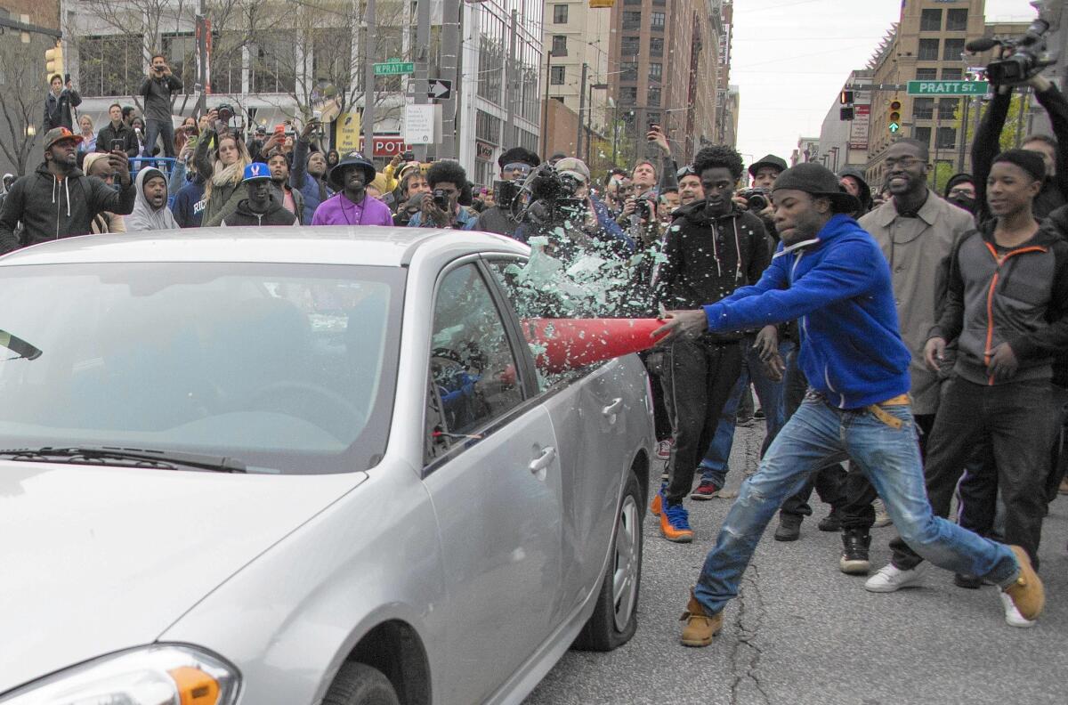 Some of the thousands of protesters in Baltimore on Saturday attacked police cars and businesses. Several people were arrested.