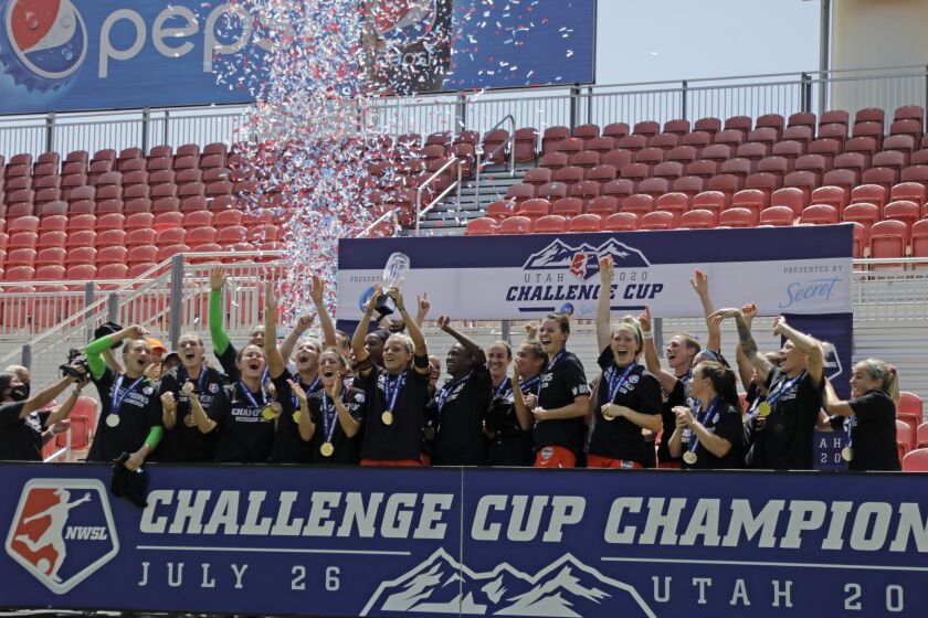 Houston Dash's Rachel Daly hoists the trophy with teammates after defeating the Chicago Red Stars to win the championship soccer game of the NWSL Challenge Cup Sunday, July 26, 2020, in Sandy, Utah. (AP Photo/Rick Bowmer)