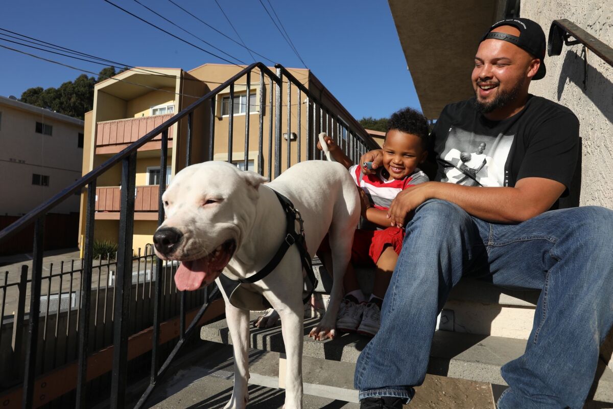 Rob Jenkins spends time with his 4-year-old son, Cash, and his dog, Sadie, at home in Oakland. He was convicted of growing marijuana a decade ago, but his record has since been expunged.