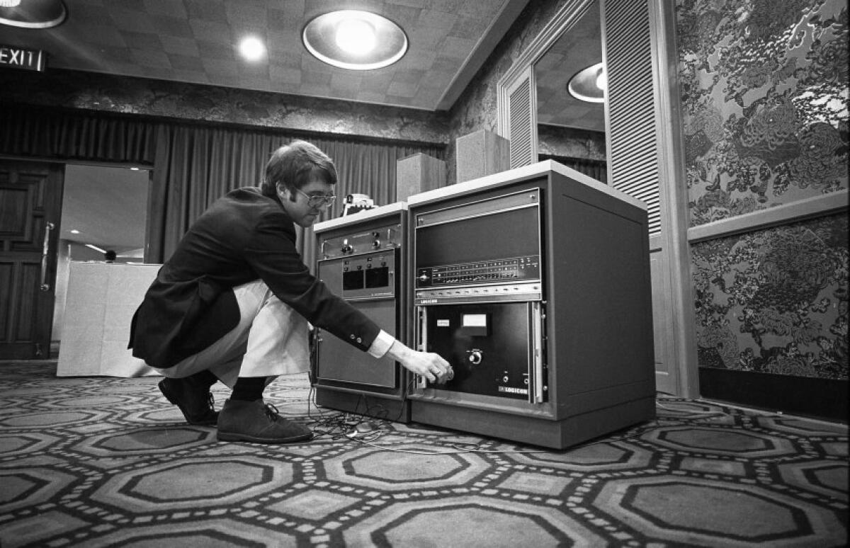 Mike Grady, an engineer with Logicon Corp., adjusts the controls of a computer that understands human speech and responds