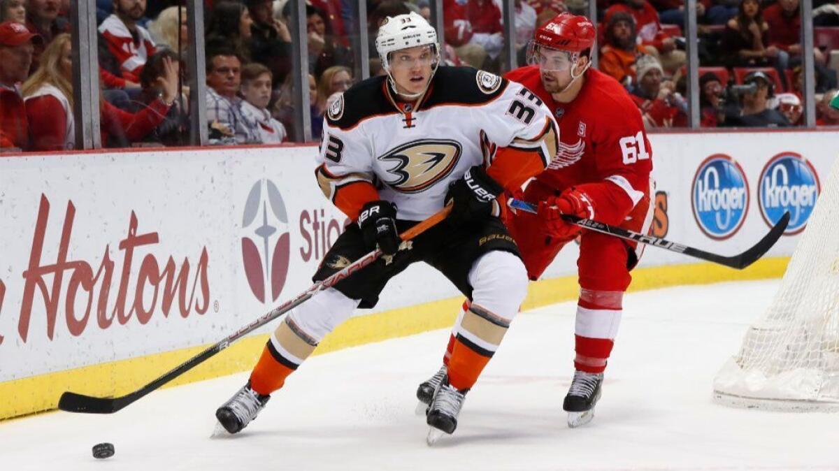 Ducks forward Jakob Silfverberg skates with the puck while being defended by Detroit Red Wings defenseman Xavier Ouellet on Dec. 17.