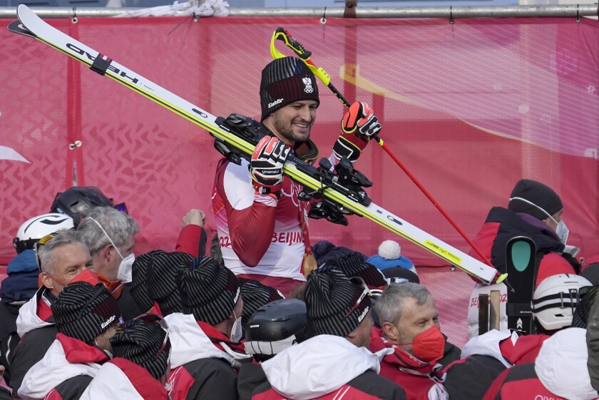 Johannes Strolz, of Austria, gold, celebrates with teammates after the medal ceremony for the the men's combined at the 2022 Winter Olympics, Thursday, Feb. 10, 2022, in the Yanqing district of Beijing. (AP Photo/Luca Bruno)